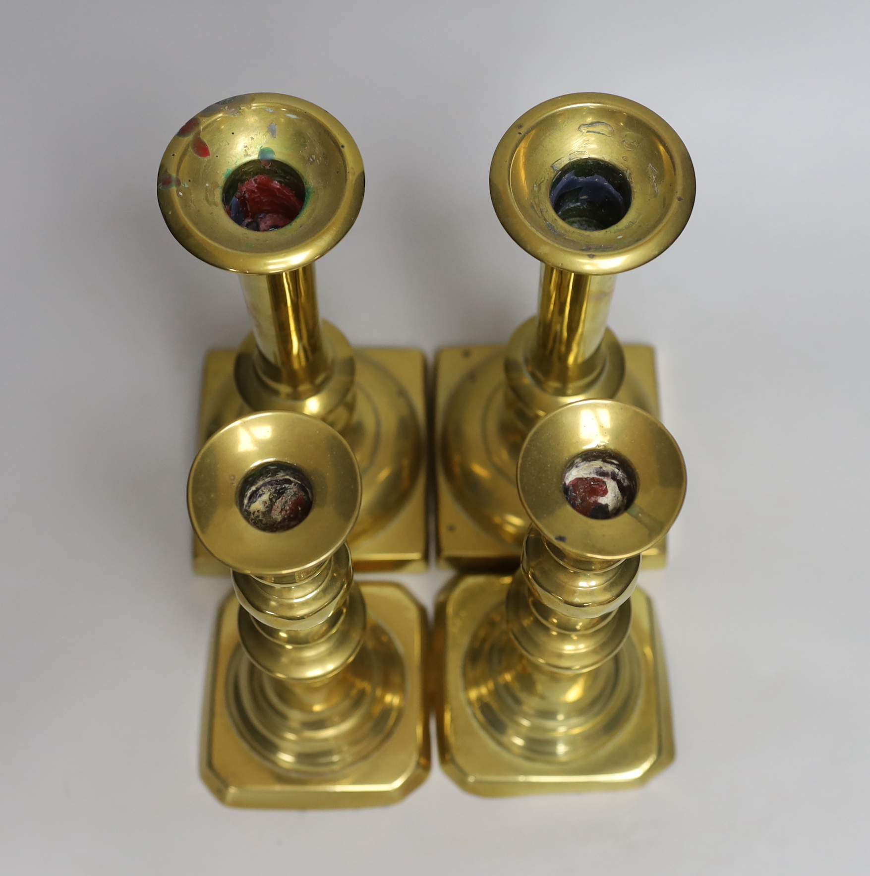 Two pairs of 19th century brass candlesticks and a Coalbrookdale iron tobacco box and cover, tallest candlesticks 24cm high
